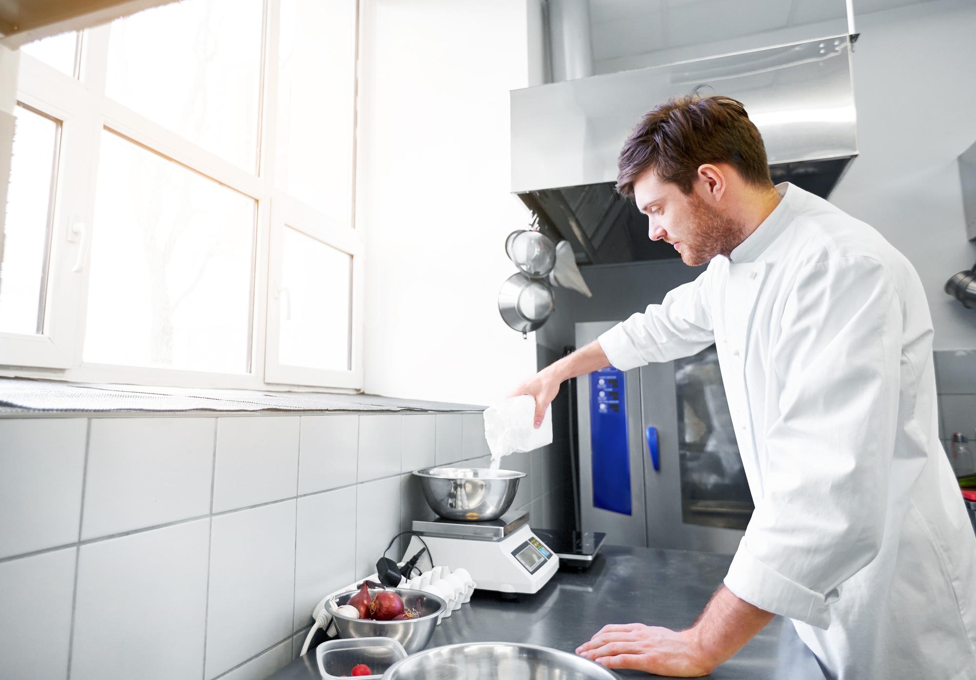 Chef calibrating a modern kitchen device